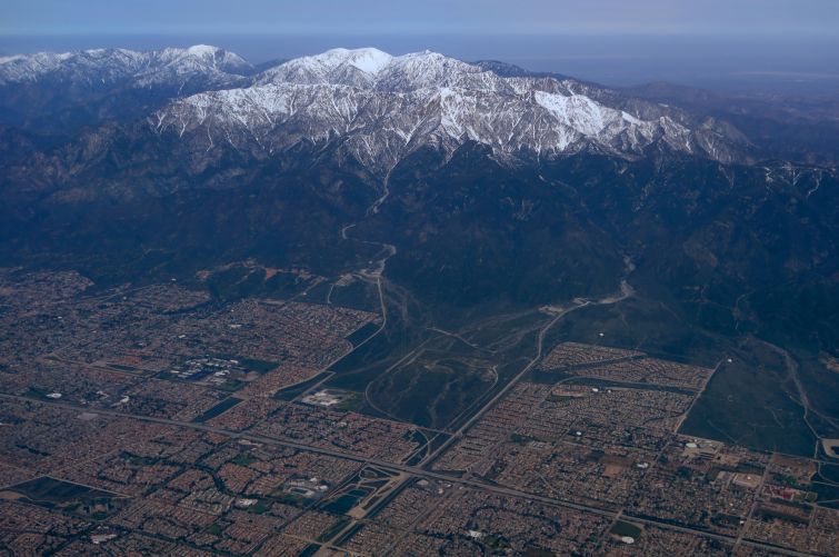 The snow covered San Gabriel Mountains are seen from a United Airlines airplane over San Bernardino County as it makes its way to Los Angeles in April.