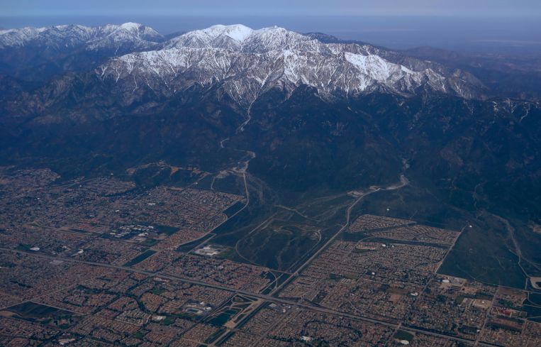 The snow covered San Gabriel Mountains are seen from a United Airlines airplane over San Bernardino County as it makes its way to Los Angeles in April.