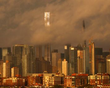 The sun sets on the skyline of midtown Manhattan, Central Park Tower, and the Steinway Tower on Billionaires' Row as rain clouds clear out of New York City on September 18, 2023.