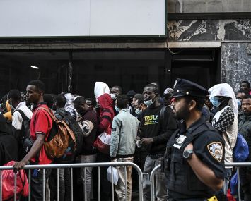 Migrants outside of the Roosevelt Hotel in Manhattan in August.