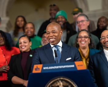 Mayor Eric Adams speaking at a podium.