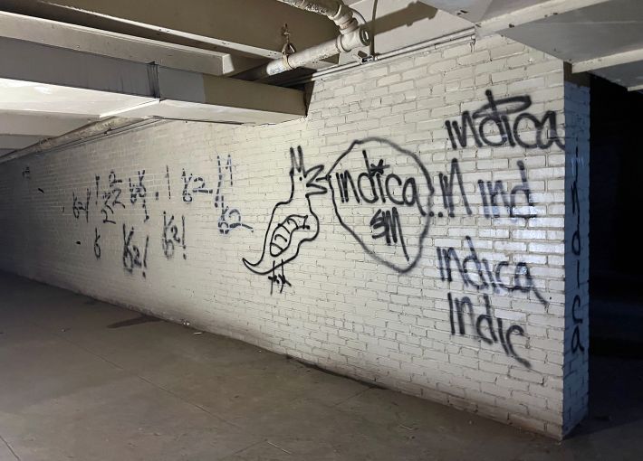 Graffiti is scrawled on a wall in the armory's windowless sub-basement.