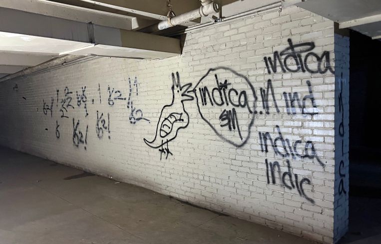 Graffiti is scrawled on a wall in the armory's windowless sub-basement.