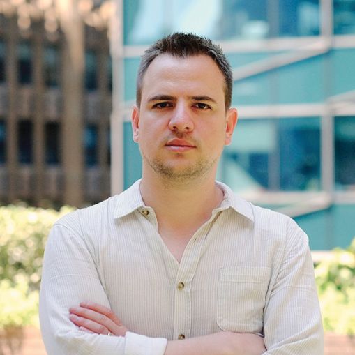 A man standing with his arms folded.