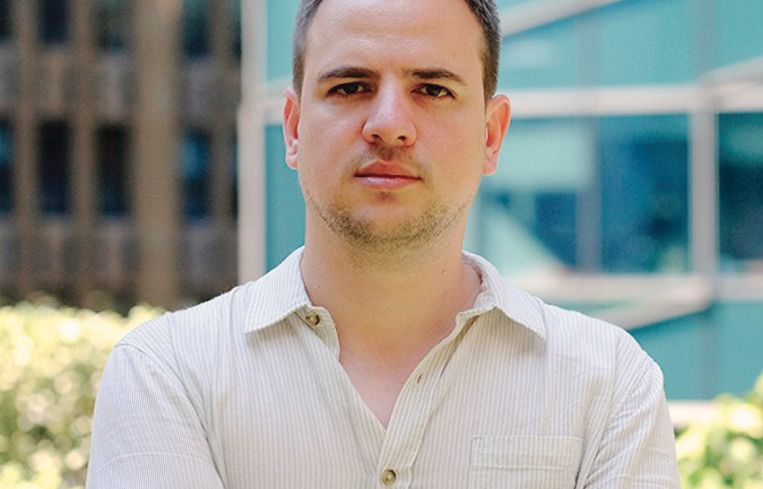 A man standing with his arms folded.