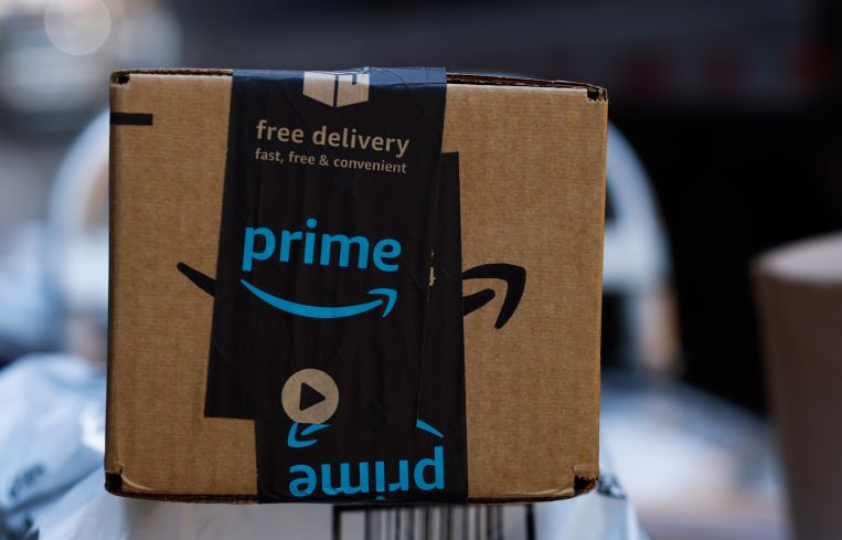 Amazon boxes loaded in a truck. The owners of a 7-acre Amazon-leased property with outdoor storage space and a 27,350-square-foot industrial building in Southern California secured $20 million in refinancing.