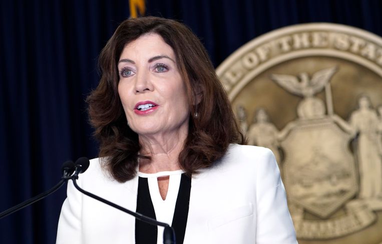 Governor Kathy Hochul in a white blazer.
