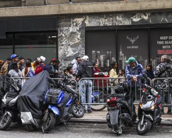 Asylum seekers line up in front of the historic Roosevelt Hotel, converted into a city-run shelter for newly arrived migrant families in New York City.