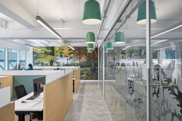 Central Park Conservancy incorporated green fixtures, large photos of the park and blonde wood to give its new offices a natural vibe. 