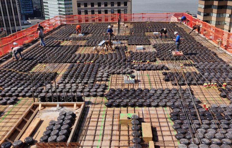 DeSimone used plastic cylinders to make new concrete slabs at One Wall Street lighter, which meant the building required less reinforcement.