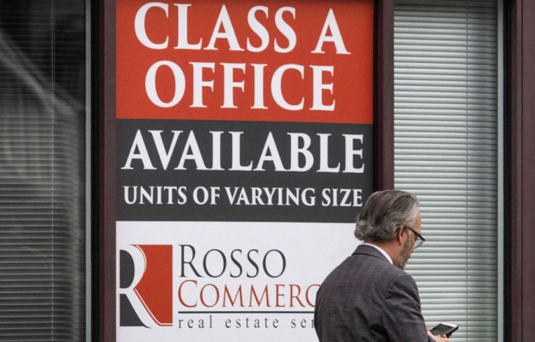 Man walks by for lease sign