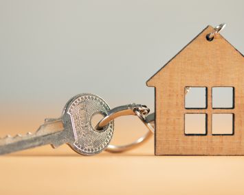 Keys from house on wooden background