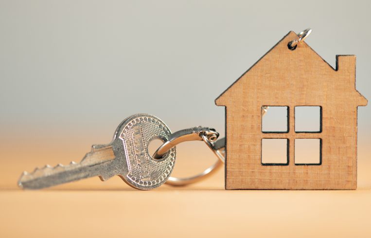 Keys from house on wooden background