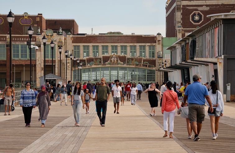 People walk along the boardwalk outside the Asbury Park Convention Hall in Asbury Park, N.J.