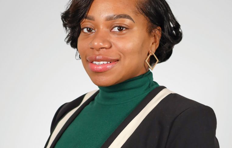 A person in a black and green shirt.