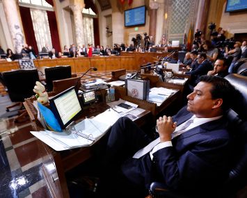 Former Los Angeles City Councilmember Jose Huizar, listens as speakers deliver arguments at Los Angeles City Hall. Former Councilman Mitch Englander sits behind him.