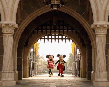 Mickey and Minnie Mouse are seen walking through Sleeping Beauty Castle.