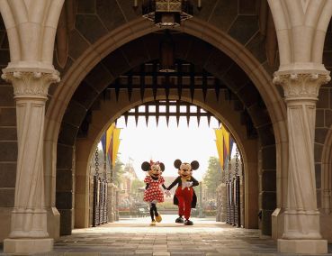 Mickey and Minnie Mouse are seen walking through Sleeping Beauty Castle.