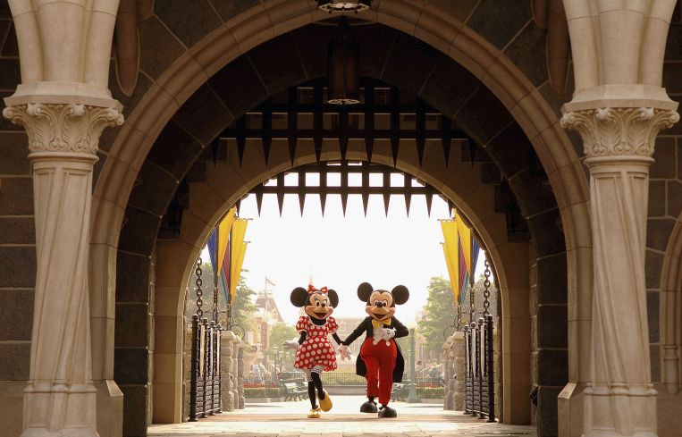 Mickey and Minnie Mouse are seen walking through Sleeping Beauty Castle.