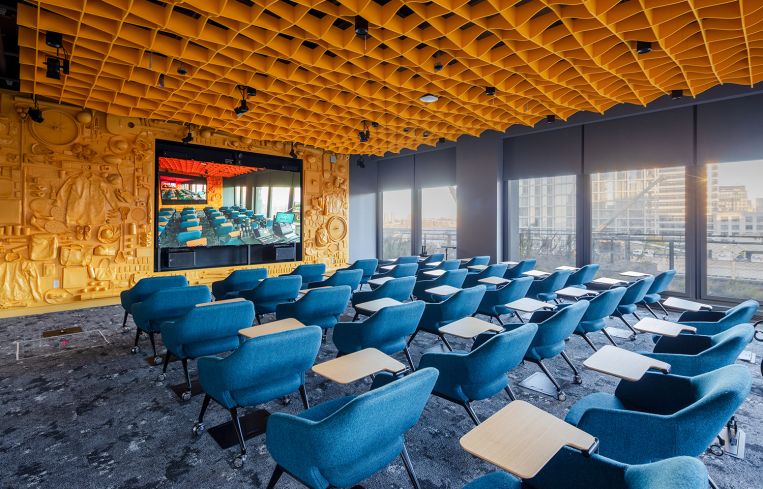 Upstairs conference rooms feature eclectic NYC themes, like this bright yellow room with one wall decorated with bike parts, umbrellas, hats, backpacks and other staples of New York commutes.