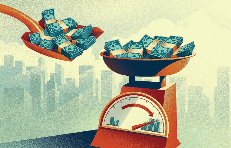 Money being shoveled onto a scale