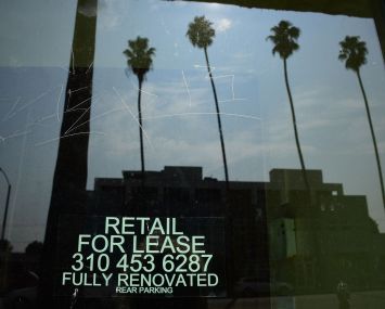 Empty storefront shop with "For Lease" signs are seen on Santa Monica Boulevard in Los Angeles.