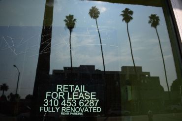 Empty storefront shop with "For Lease" signs are seen on Santa Monica Boulevard in Los Angeles.