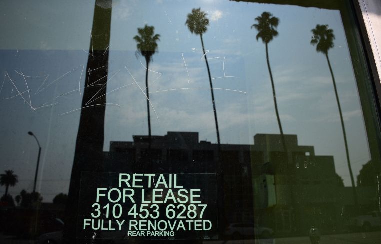 Empty storefront shop with "For Lease" signs are seen on Santa Monica Boulevard in Los Angeles.