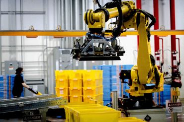 A robot sorts and stacks bins at a fulfillment center in the Inland Empire.