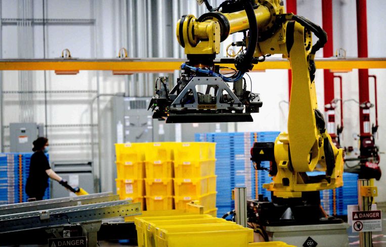 A robot sorts and stacks bins at a fulfillment center in the Inland Empire.