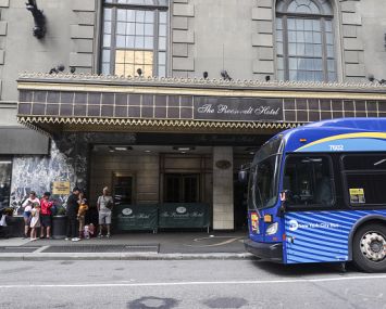 Asylum seekers line up in front of the Roosevelt Hotel, converted into a city-run shelter for newly arrived migrant families in New York City, in late September 2023.