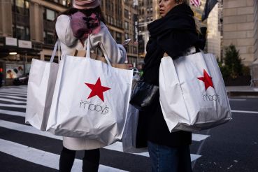 Shoppers carry Macy's bags in New York