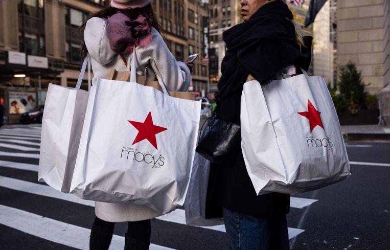 Shoppers carry Macy's bags in New York
