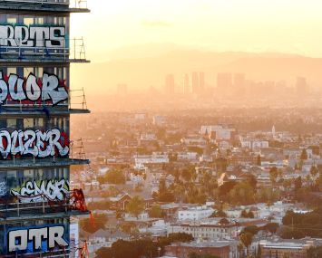 An aerial view of graffiti spray painted by taggers on at least 27 stories of an unfinished skyscraper development in Downtown L.A. Construction of the $1 billion Oceanwide Plaza luxury real estate development stalled in 2019 after a China-based developer ran out of funding leaving the three-tower project uncompleted. The project is located across the street from the Crypto.com Arena. (The graffiti remains as of February 22.)