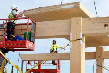 Builders in San Francisco place cross-laminated timber into position.