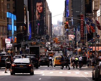 A busy street with cars and pedestrians.
