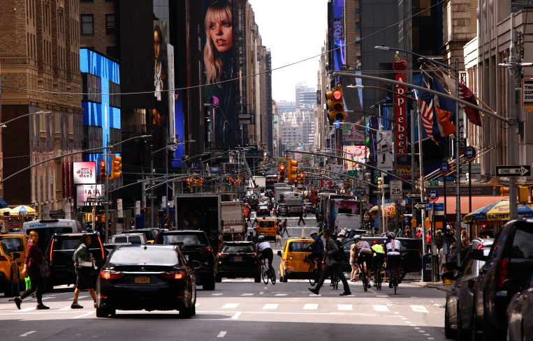 A busy street with cars and pedestrians.