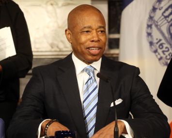 A man in a suit at a podium.