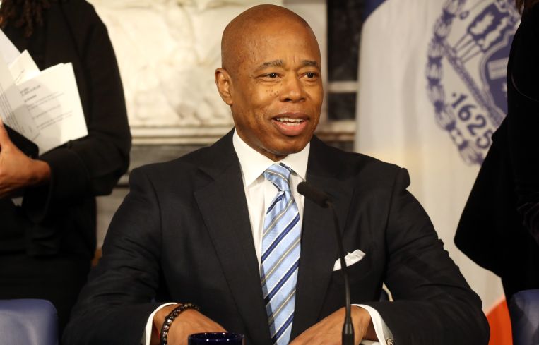A man in a suit at a podium.