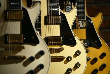 Les Paul Custom guitars at a Guitar Center store.