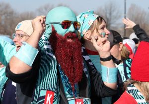 Fans dance as they wait to enter CPKC Stadium.