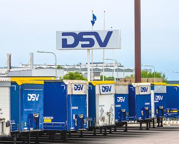 Row of DSV freight trailers at a parking lot.