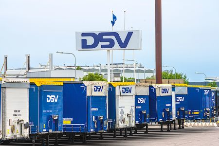 Row of DSV freight trailers at a parking lot.