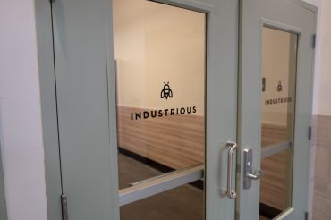 Logo on interior door of coworking space Industrious.