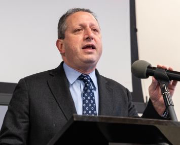 A man in a suit at a podium.