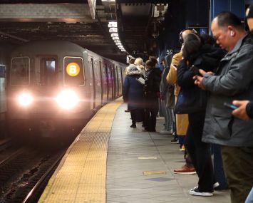 Passengers wait for a train at Columbus Circle Station in New York City