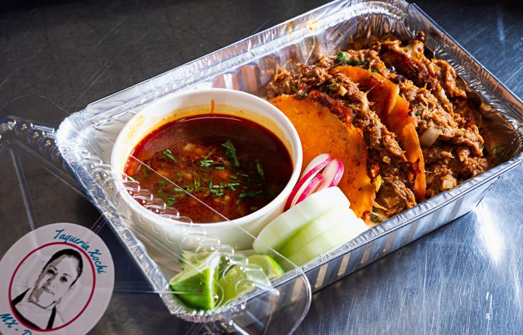Lamb quesabirria with dipping sauce at Taqueria Xochi