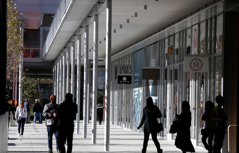 Shoppers explore the City Center Bishop Ranch outdoor shopping mall.