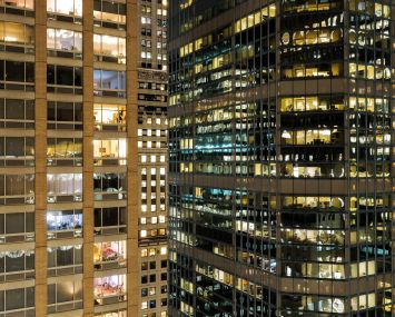 Residential and office buildings are pictured at night in New York.
