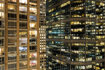 Residential and office buildings are pictured at night in New York.